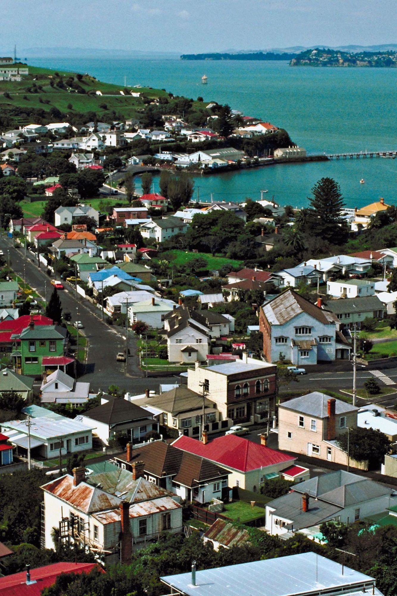 Devonport rooftops above the water, with the Hauraki Gulf and its islands beyond