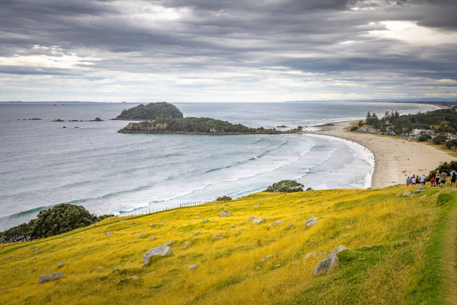 The view from the grassy slopes of Mauao over Mount Maunganui&rsquo;s Main Beach and the offshore islands