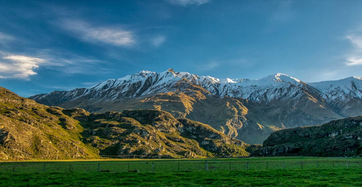 Snow-covered Southern Alps rising above a Central Otago valley