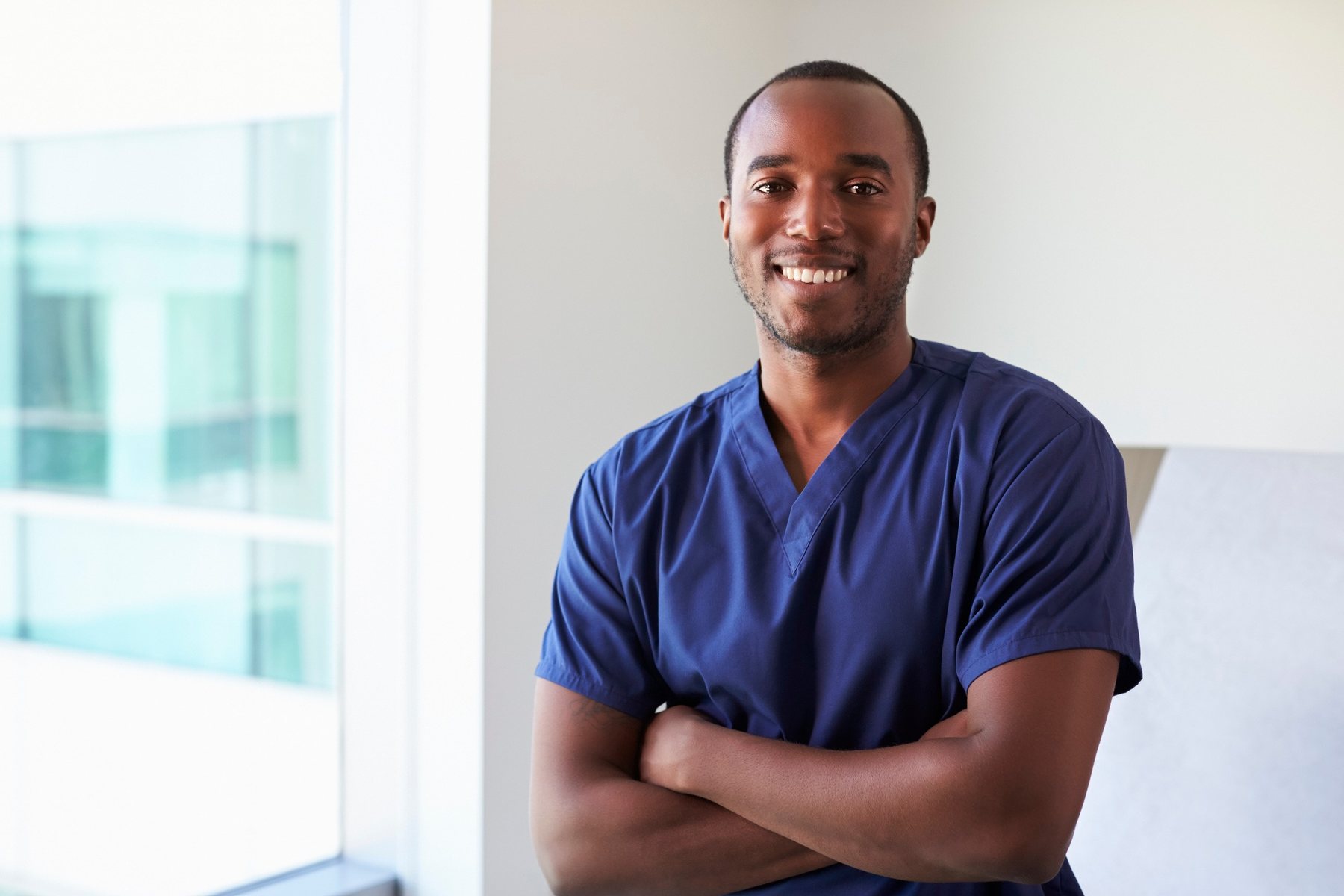 A mental health nurse in navy scrubs