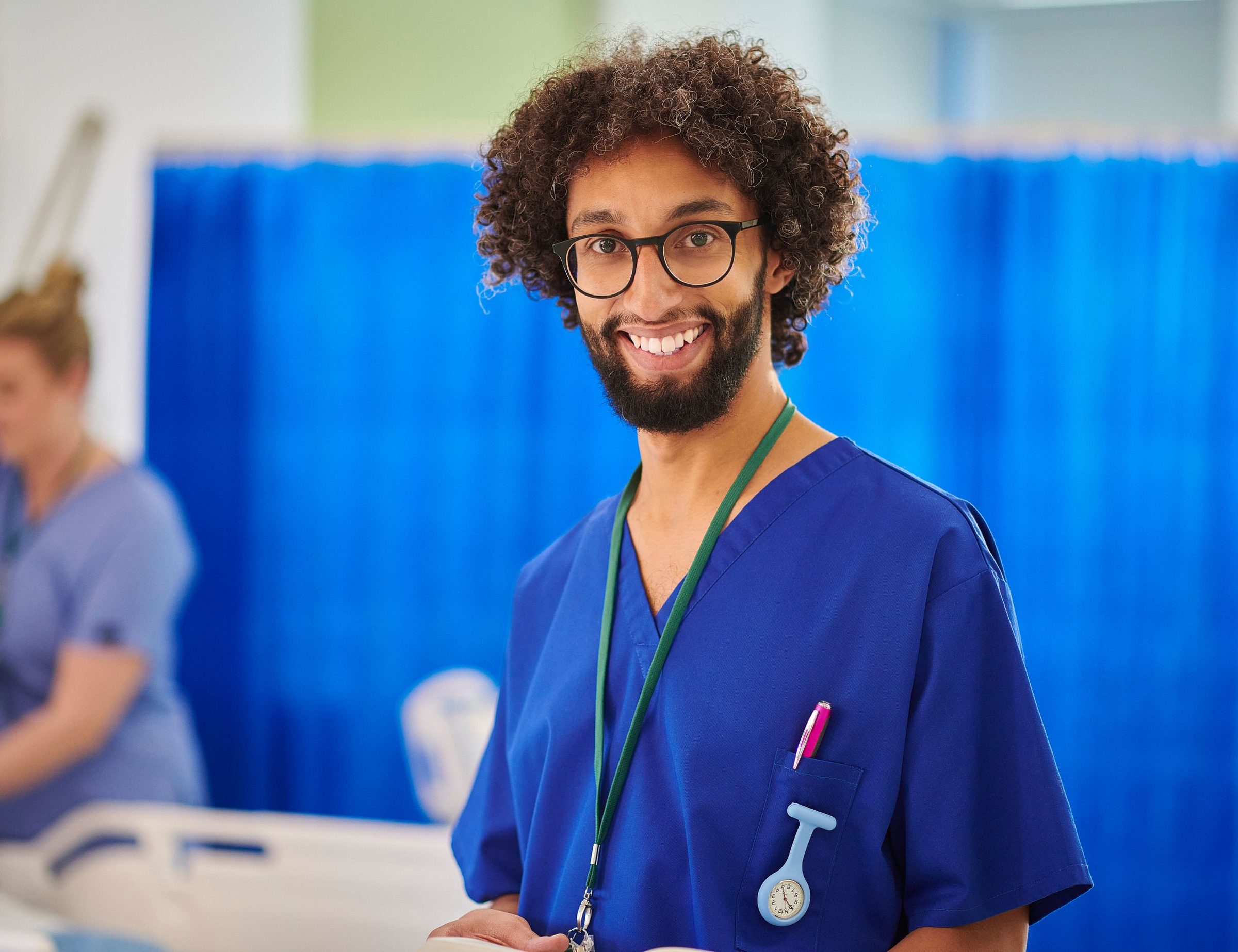 A young doctor in scrubs on a hospital ward