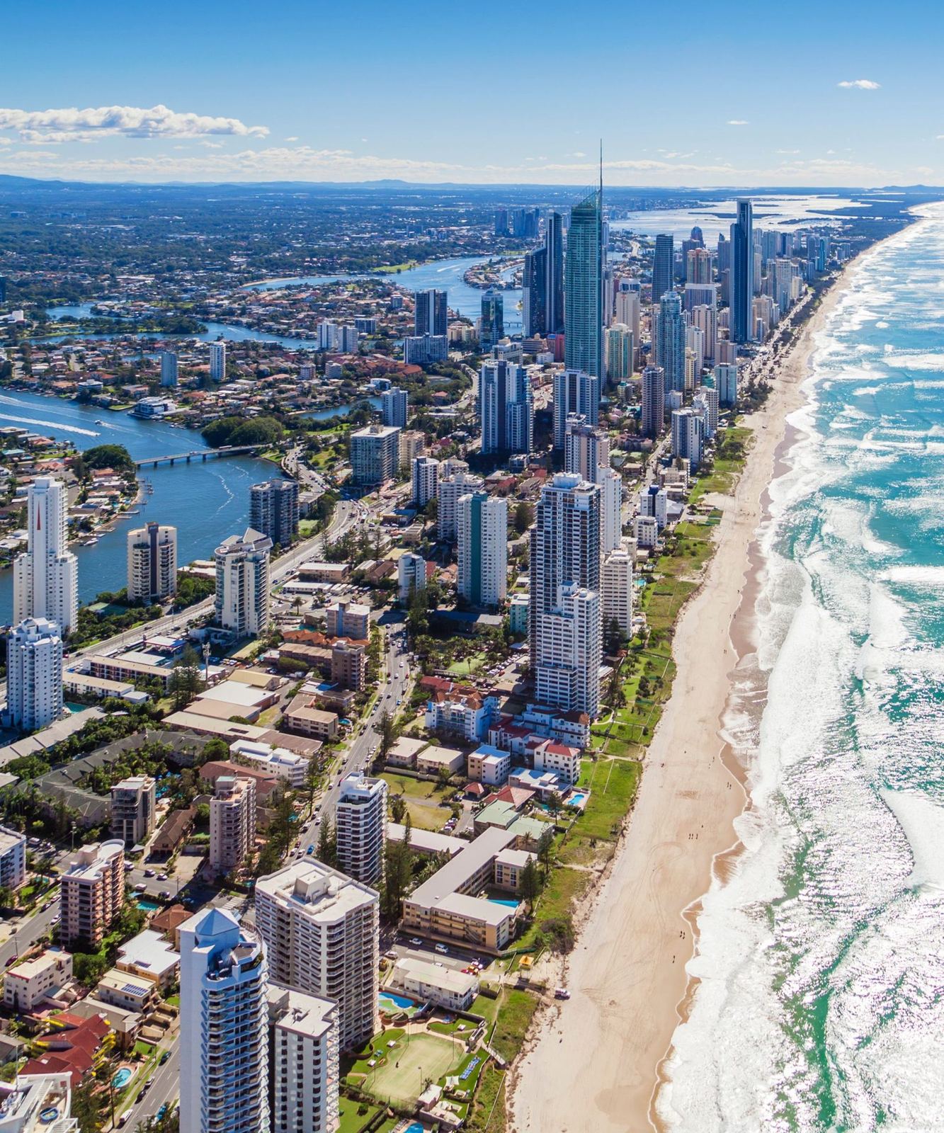 An aerial view of the Gold Coast's towers, beach and surf