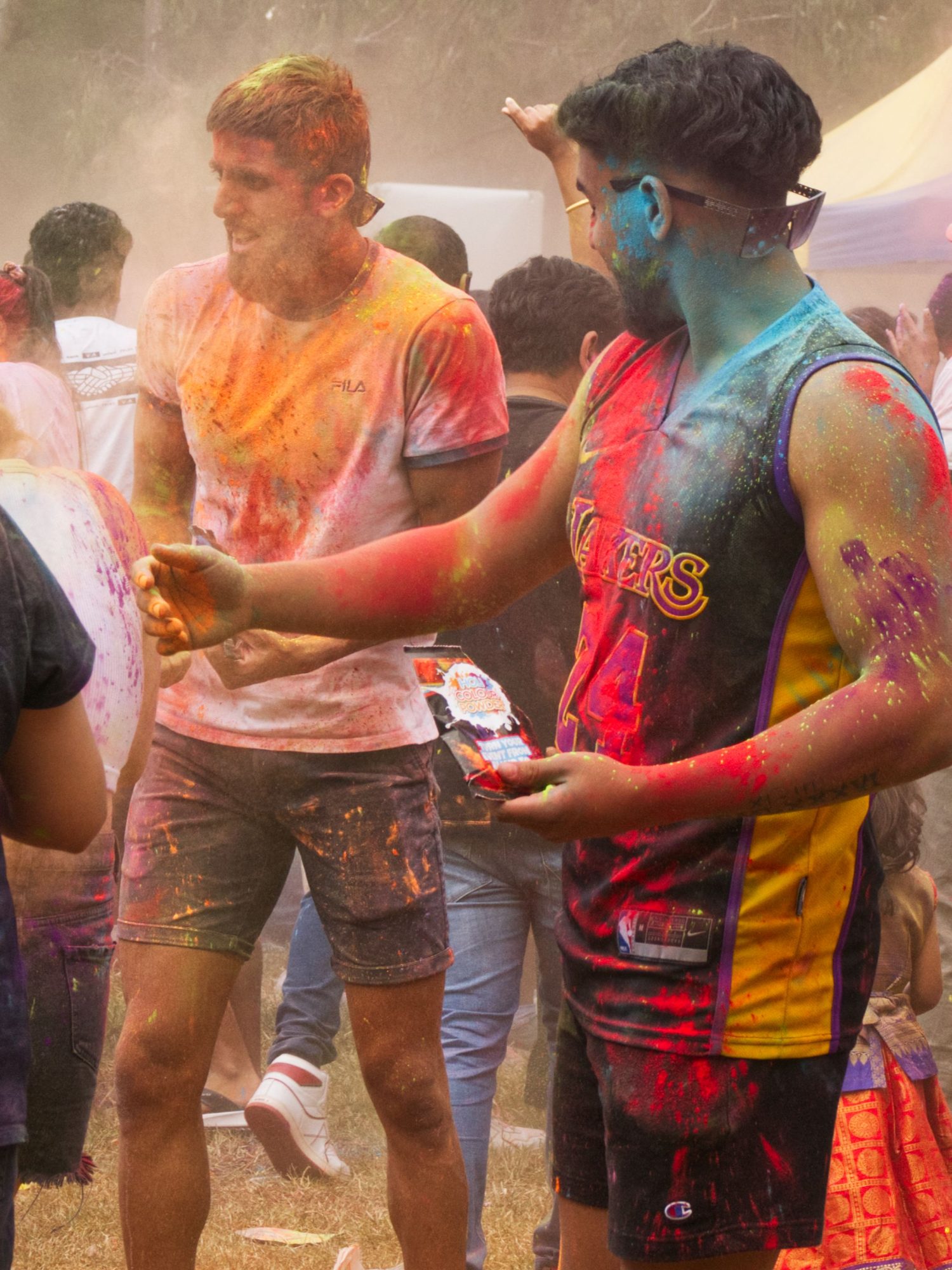 Two young men covered in powdered colour at a Holi celebration in Melbourne