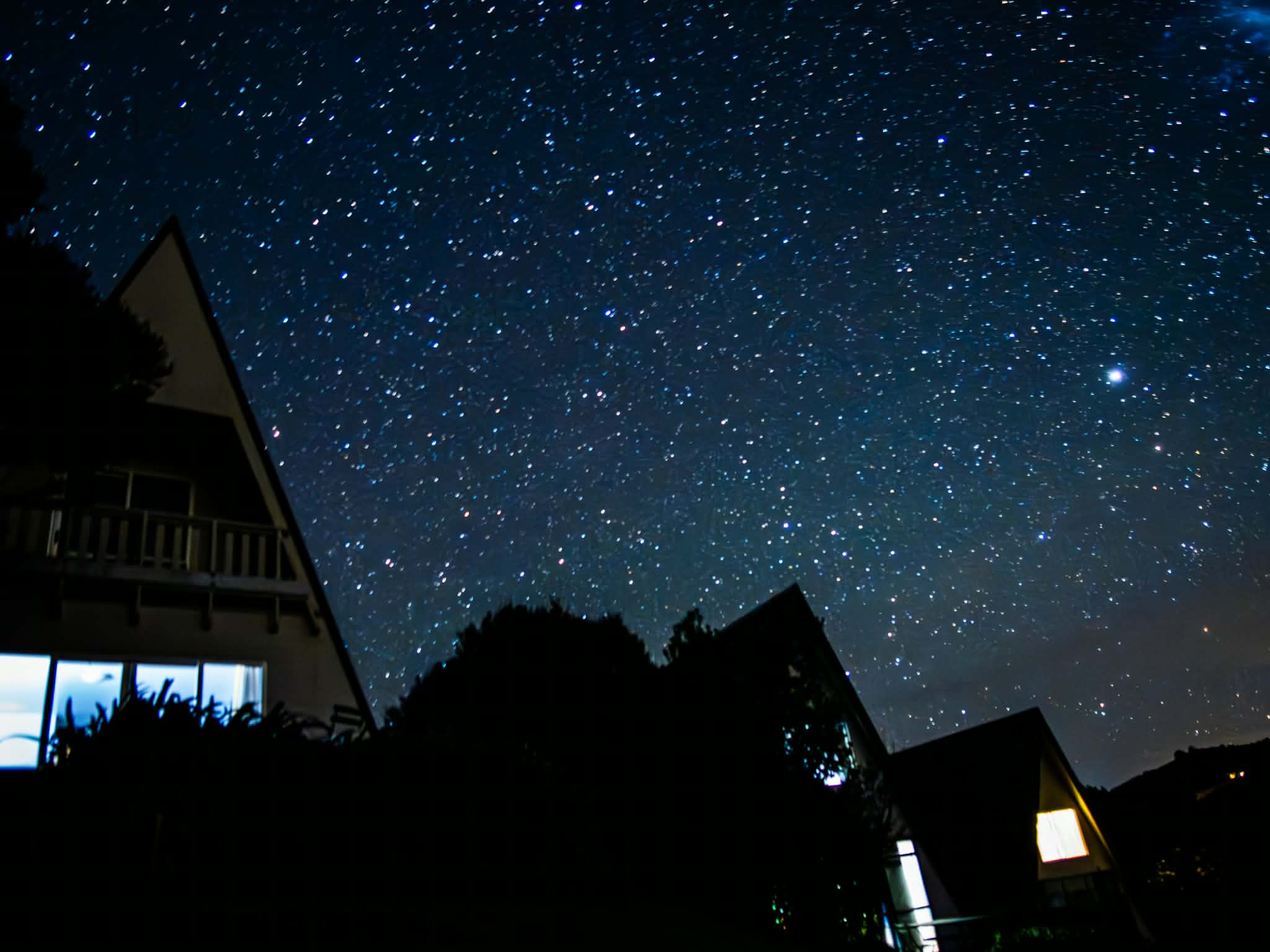 Houses under a clear, star-filled Northland night sky