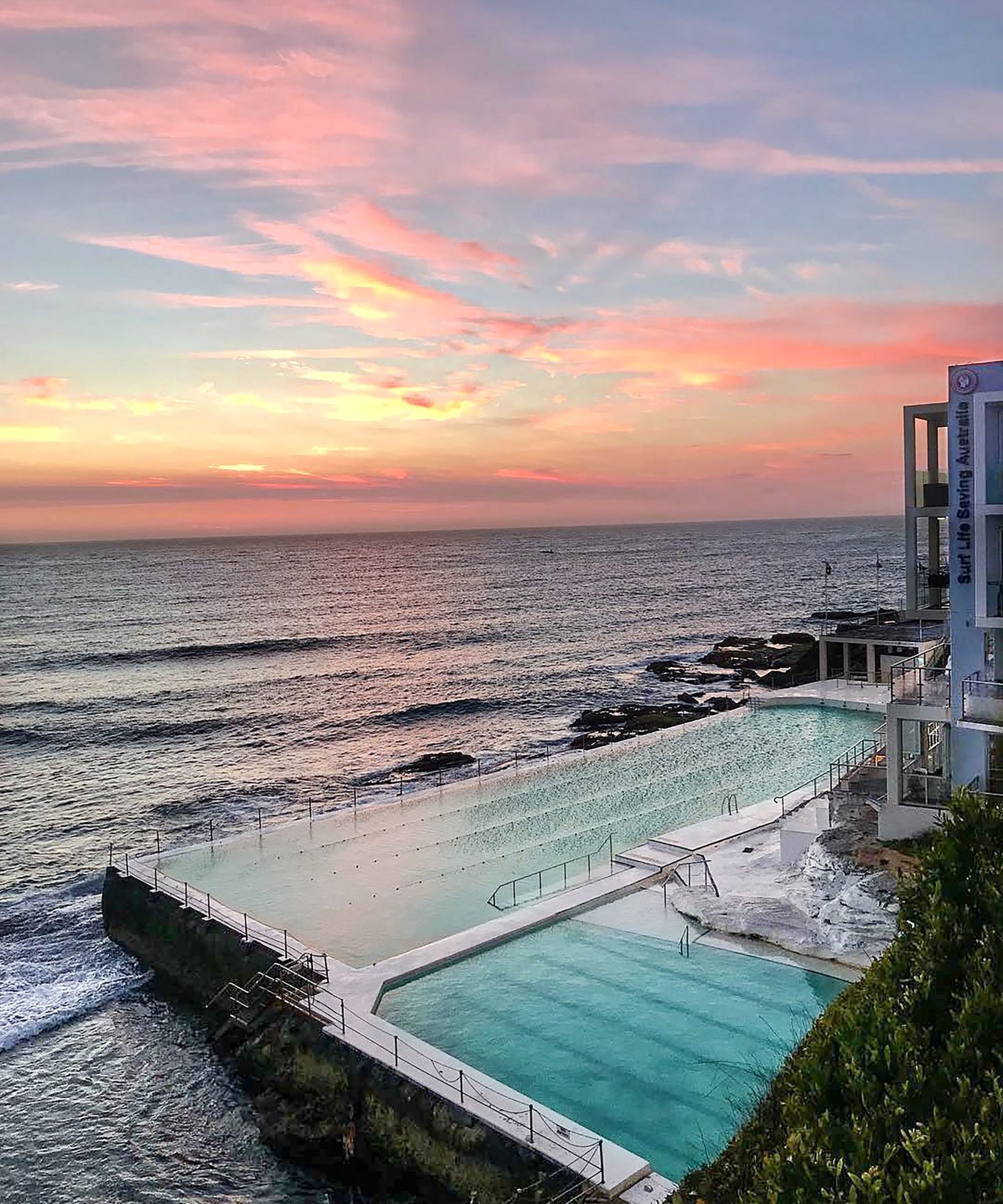 The ocean pool at Bondi Icebergs at dusk, waves breaking over the wall
