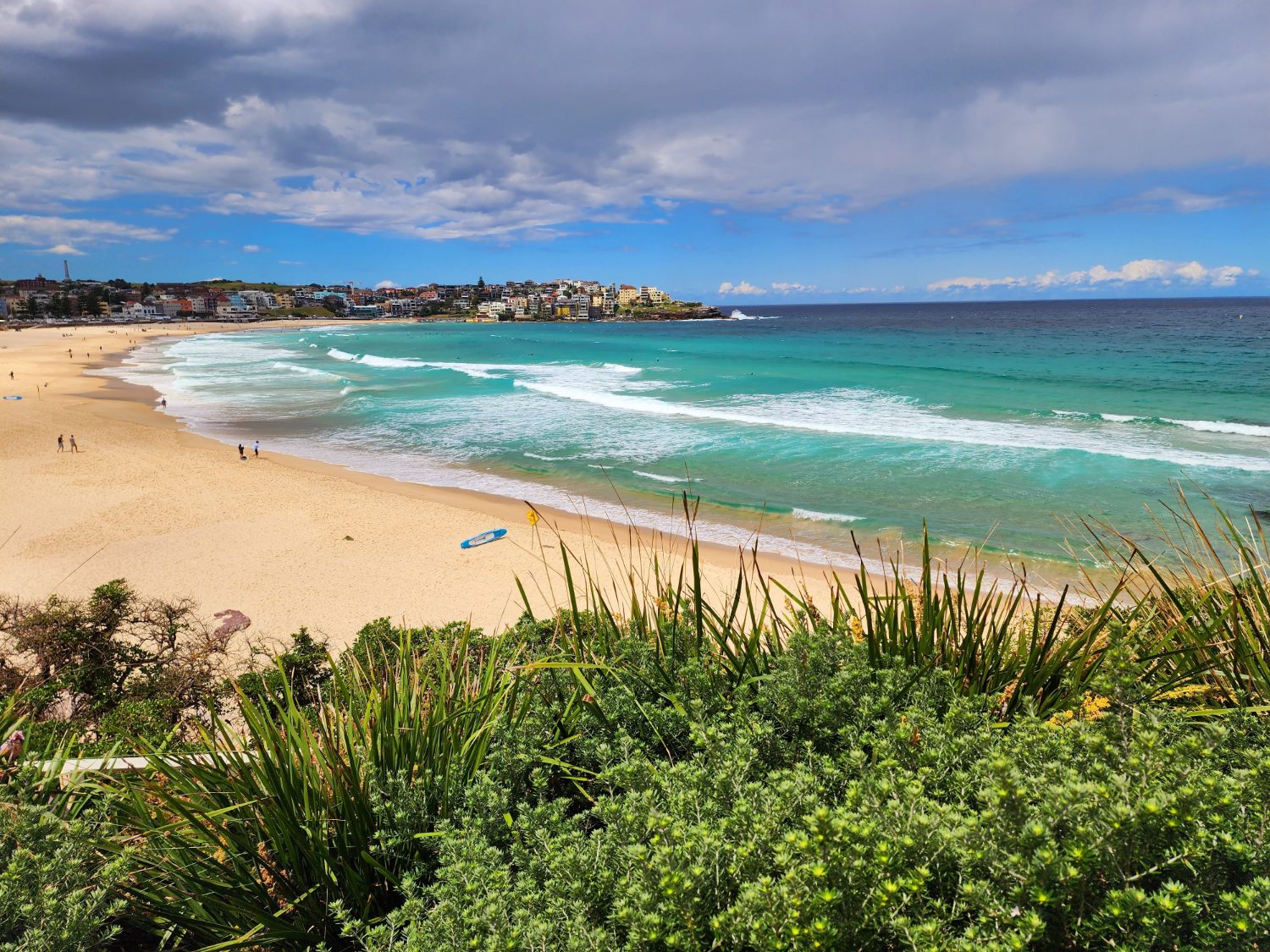 Bondi Beach with surfers and the headland beyond