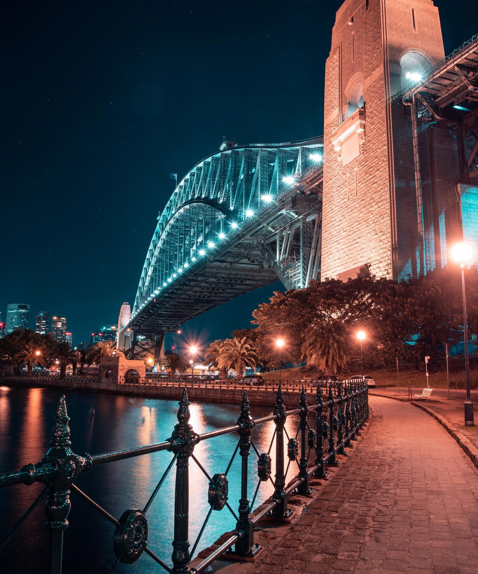 The Sydney Harbour Bridge lit up at night from the Kirribilli foreshore