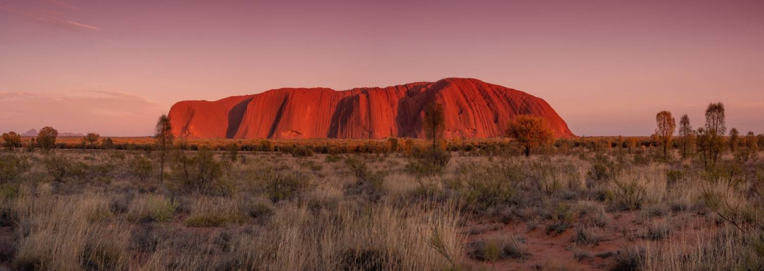 Uluru glowing deep red at dusk in the southern Northern Territory