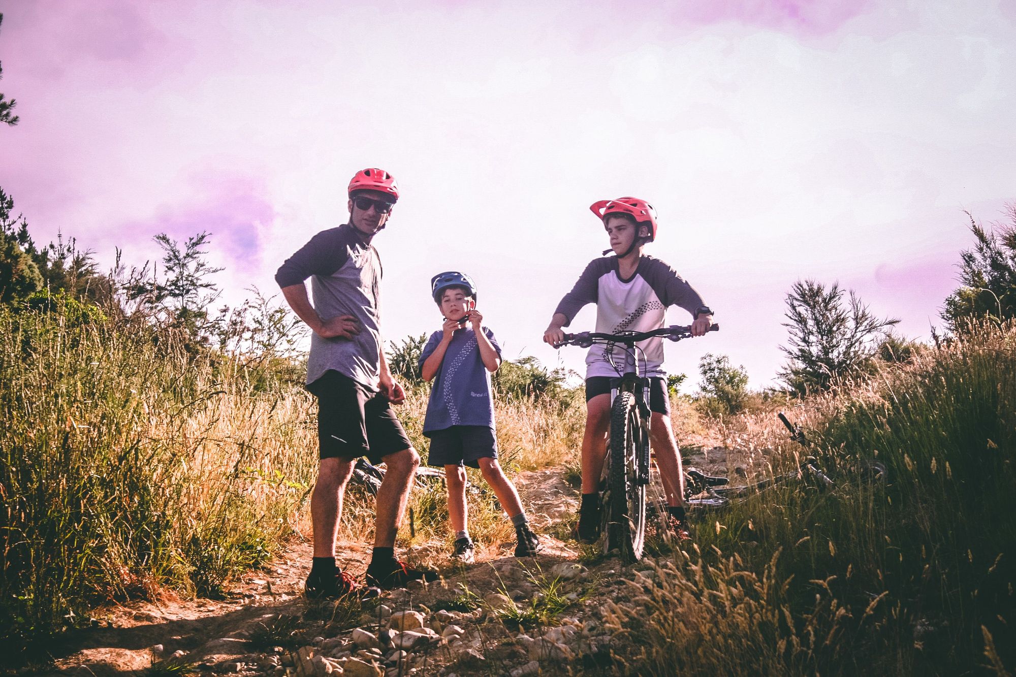 A family riding mountain bikes on a forest trail