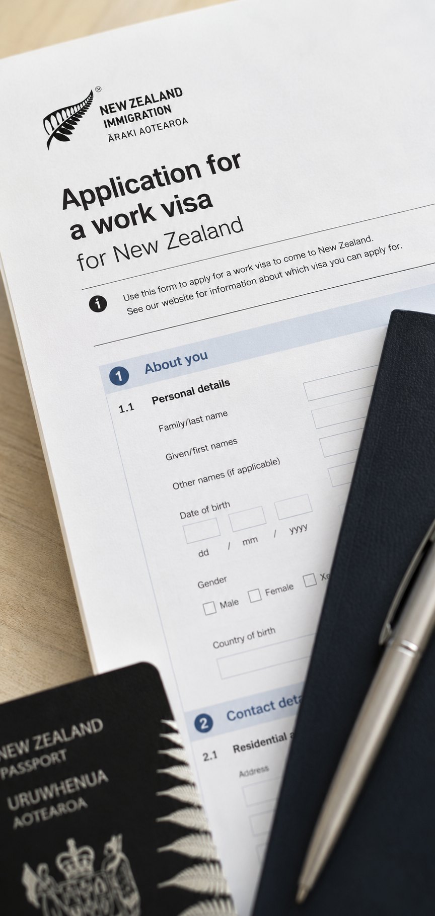A New Zealand work visa application form on a desk with a passport and pen