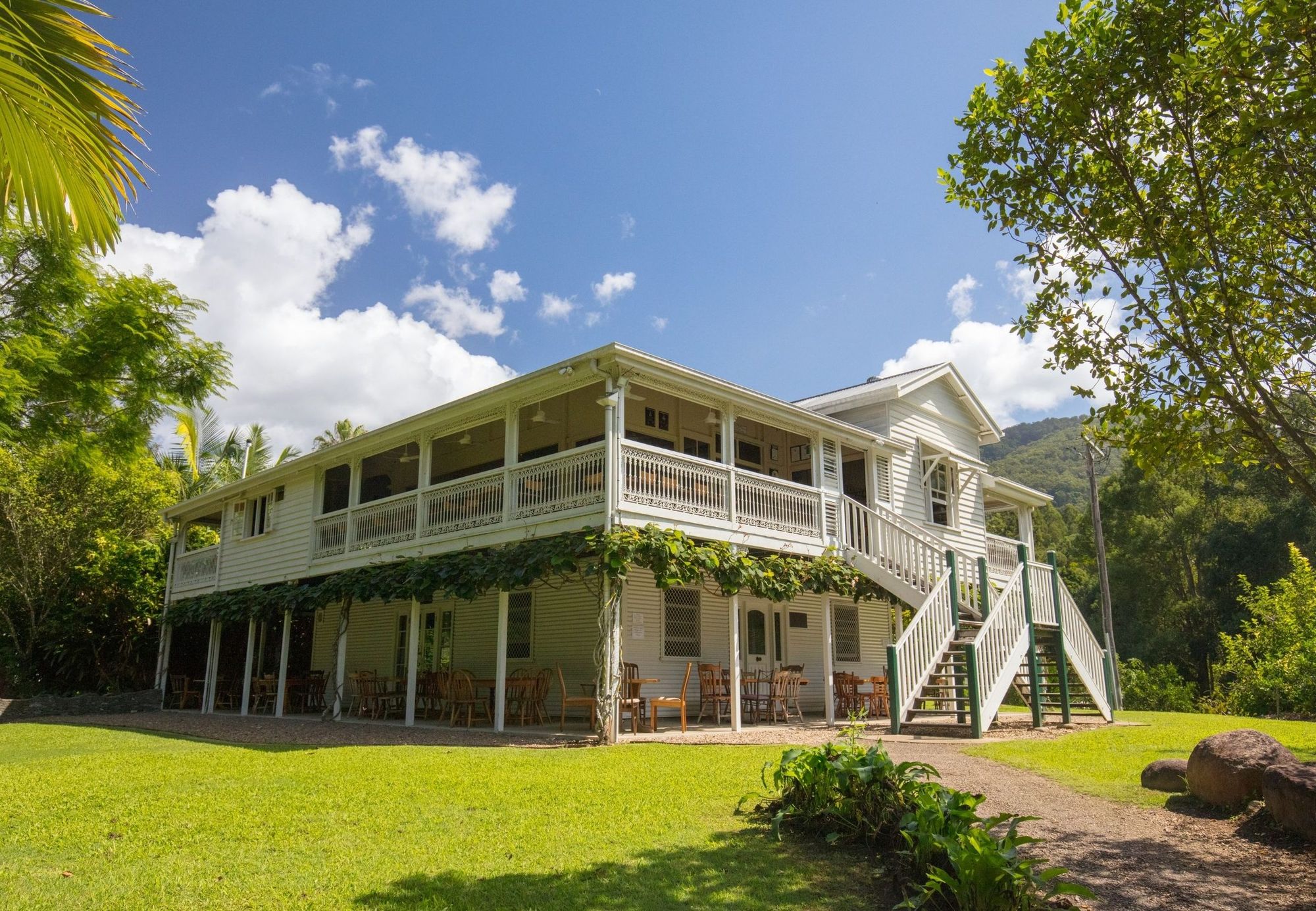 A traditional timber Queenslander house on stumps with a wraparound veranda