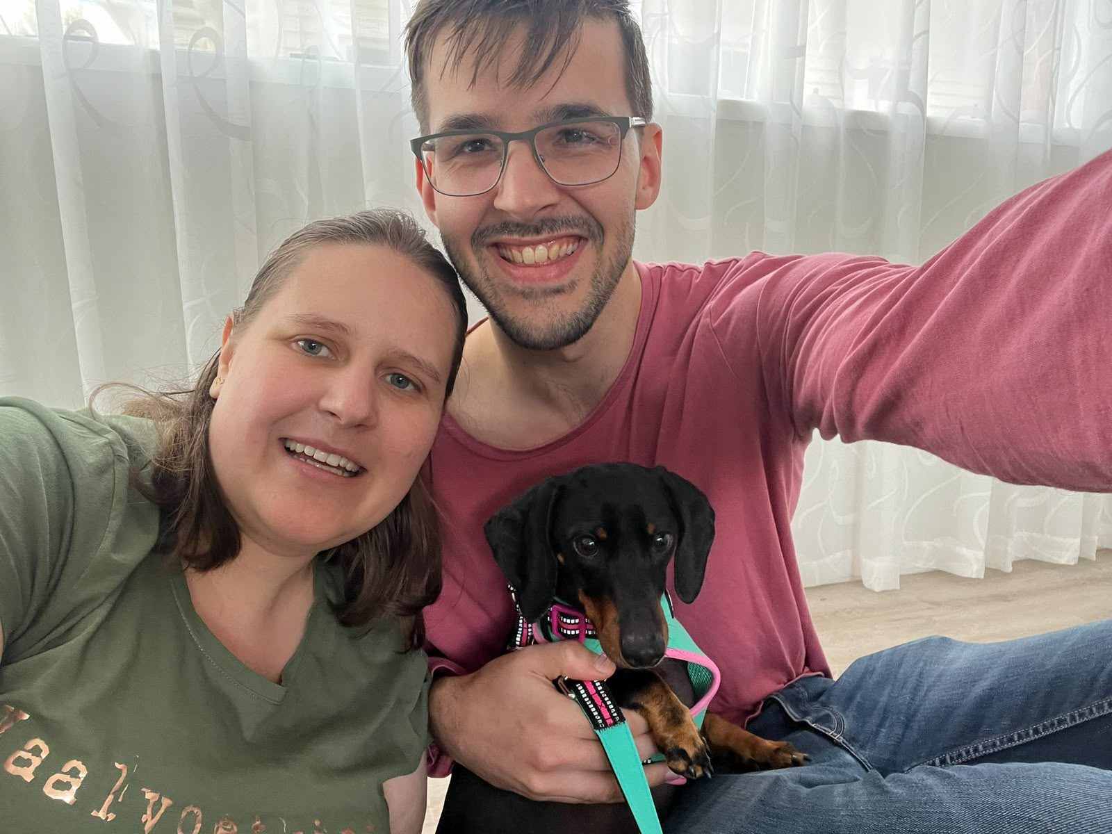 Janita and Jonathan at home in Auckland with Nova the dachshund
