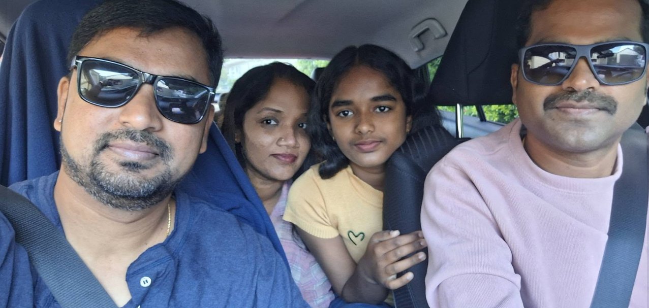 Rezon, Anu and friends smiling for a selfie in the car on a road trip